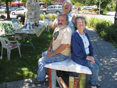 Sculpture Jam sculptors, Beth Hartmann, David Furger, Sara Schomp, enjoy thei book bench